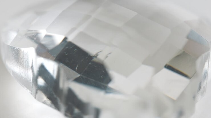 Macro Shot Of Diamond Like Quartz Rock Rotating Around With Flashing Red And Blue Light In Background