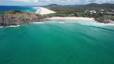 Norries-Head-And-Cabarita-Beach-With-Surfers-In-New-South-Wales,-Australia---aerial-shot