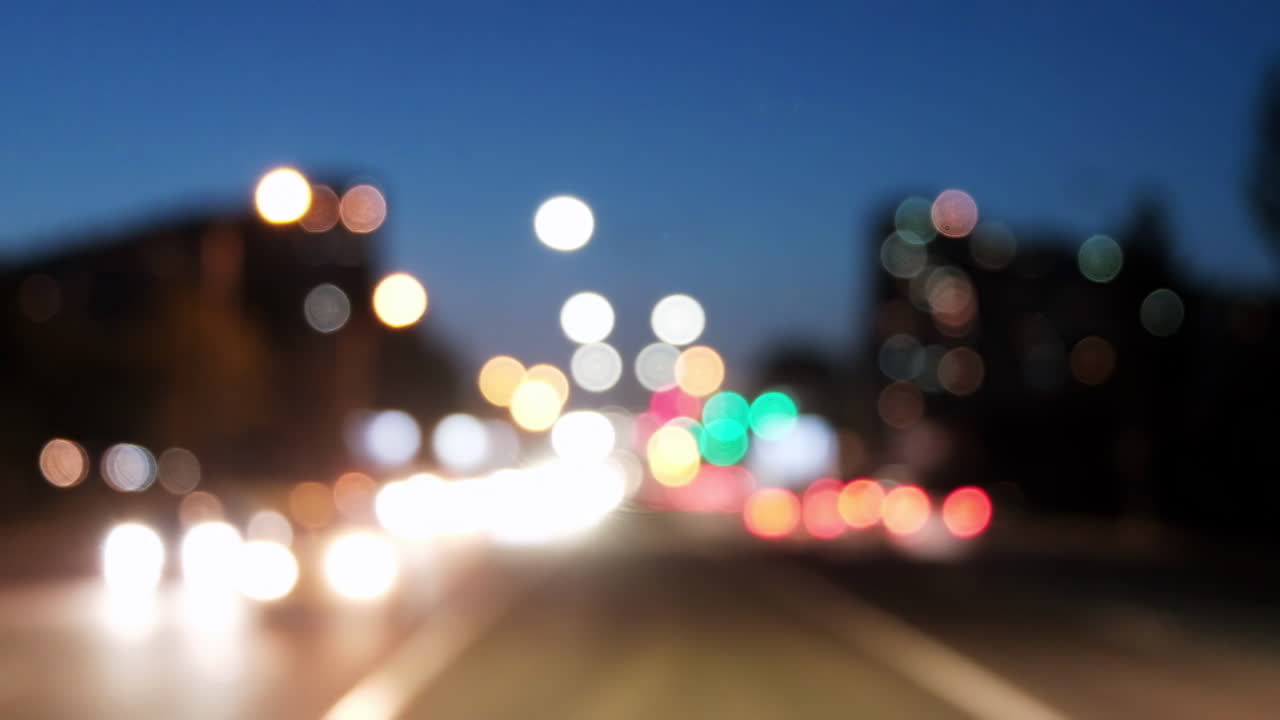 Blurred view of cars moving on the streets of the city in the evening