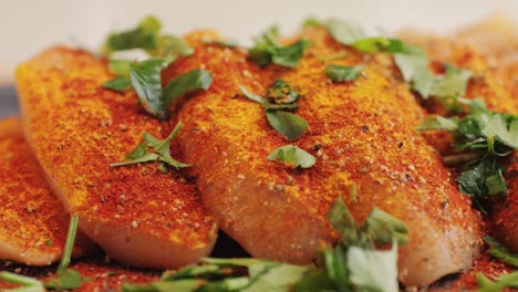raw slice chicken meat in spices: paprika, salt, pepper, turmeric on plate close-up. preparing raw food for cooking. grilled chicken, duck, turkey kebab with vegetables.