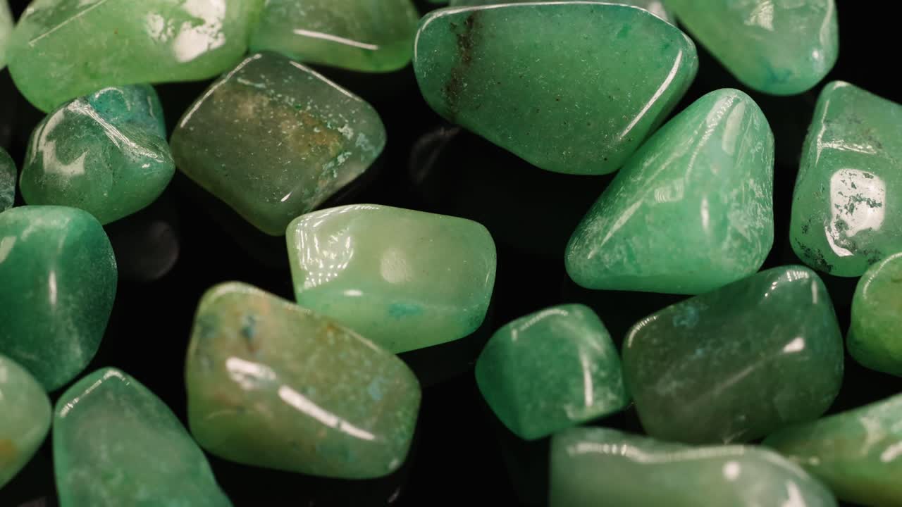 Green aventurine stones shown in detailed close-up with smooth transitions, highlighting texture and color under soft lighting