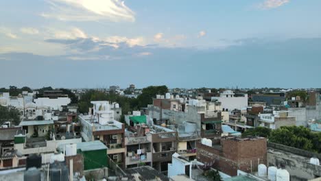 4k aerial shots of new delhi residential suburbs on a beautiful day gliding over rooftops, streets, parks and markets in india