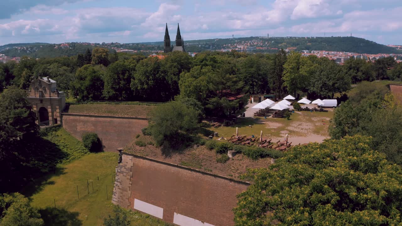 Revealing Spires Of St. Vitus Cathedral Behind Lush Trees In Prague, Czech Republic With Vltava River In Background. drone ascend