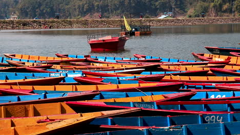 pan colorful wooden boats at the shore of begnas lake