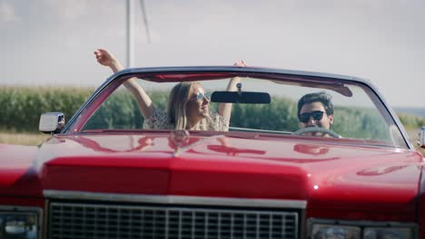 Front-view-video-of-happy-young-couple-in-a-cabriolet