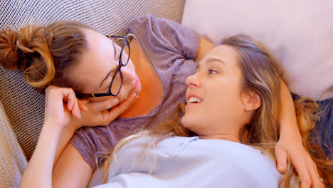 lesbian couple interacting with each other in living room 4k