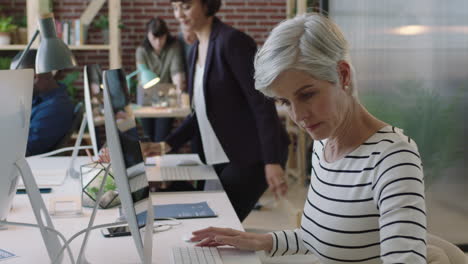 senior business woman leader using computer networking in multi ethnic office workspace colleagues working on start up project creative diverse professional team