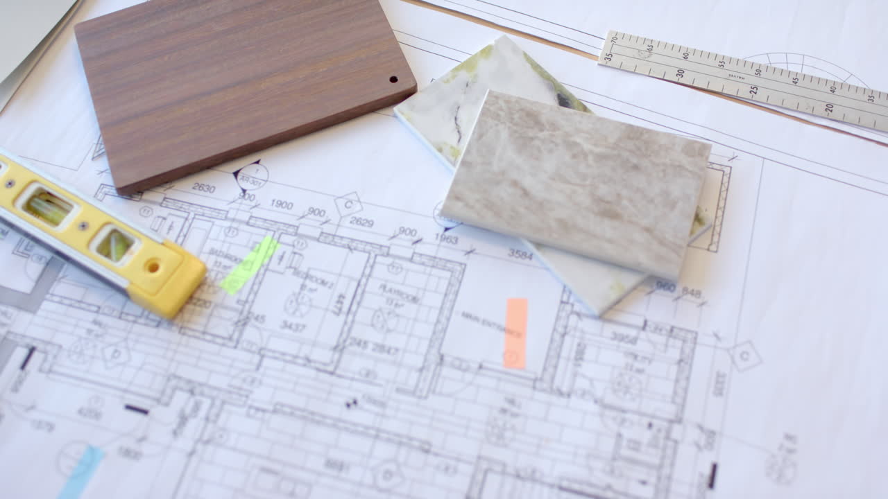 Planning construction, architectural blueprints with tile samples and measuring tools on desk