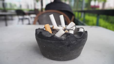 used cigarette ashtray on a restaurant table