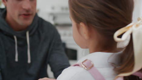 father getting daughter ready for school dad helping little girl put on backpack 4k