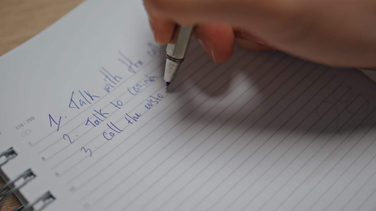Accountant hands writing notebook at workplace closeup. Man preparing to-do list