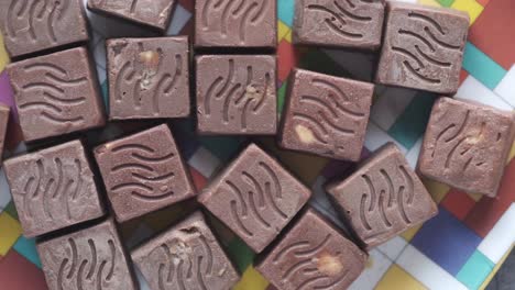 chocolate squares on a colorful plate