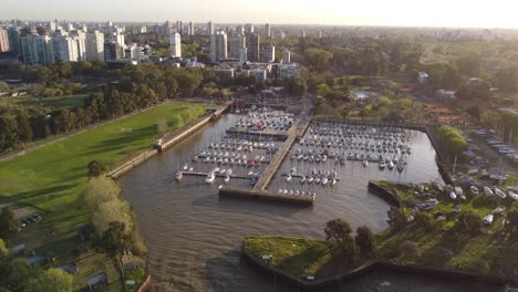 aerial view of olivos yacht club during sunset time with buenos aires cityscape in background