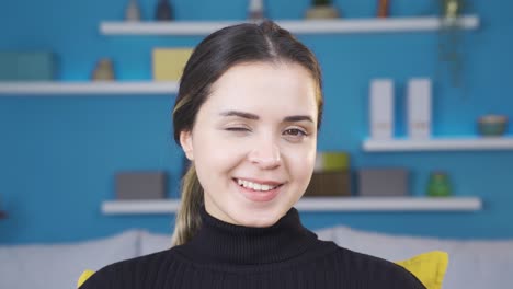 close-up of beautiful attractive young woman winking.