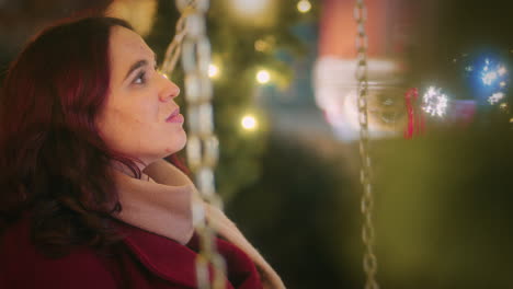 young girl on a swing at the christmas market slow motion shot