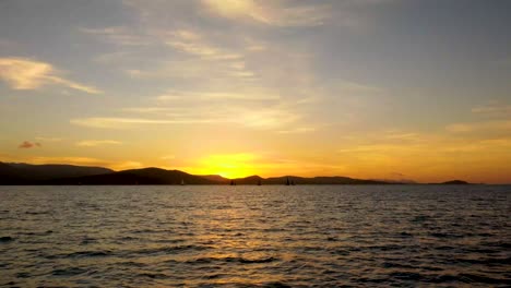 stunning sunset over the ocean with sailboats