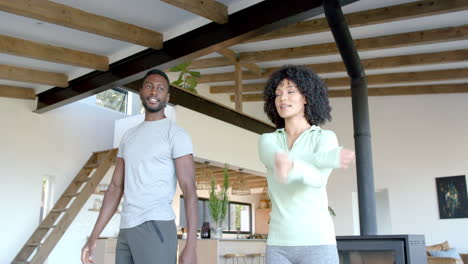 couple enjoying morning exercise routine together in cozy living room
