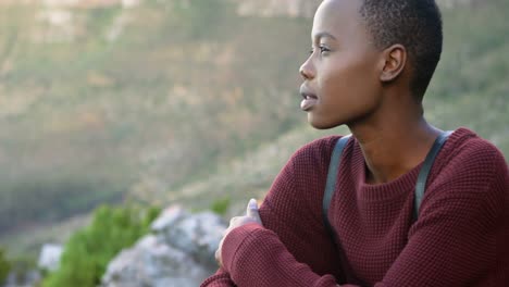 Woman-sitting-on-a-rock-at-countryside-4k