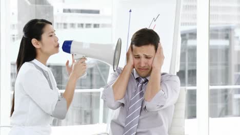 Asian-businesswoman-yelling-through-a-megaphone