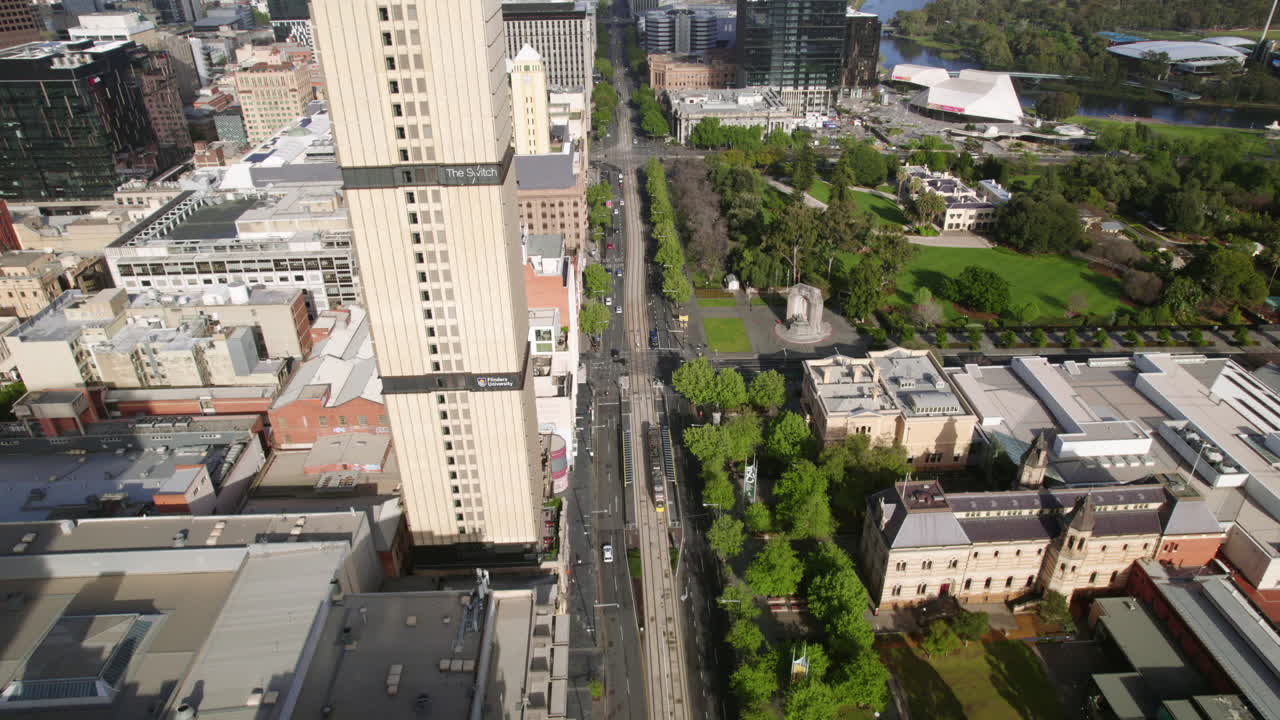 Aerial view backwards over the North Terrace road, sunny afternoon in Adelaide
