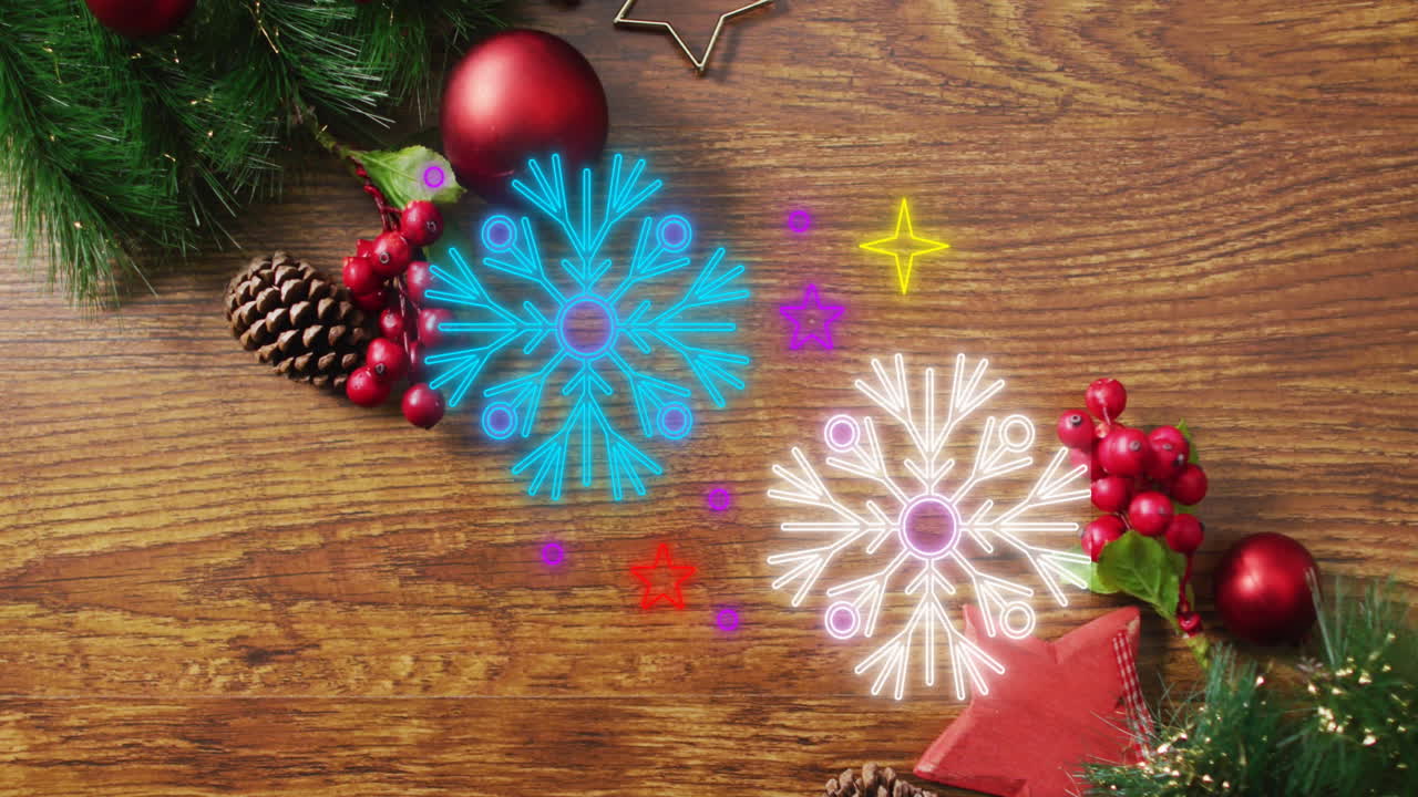 animación de iconos de copos de nieve de neón sobre decoraciones navideñas en superficie de madera con espacio de copia.