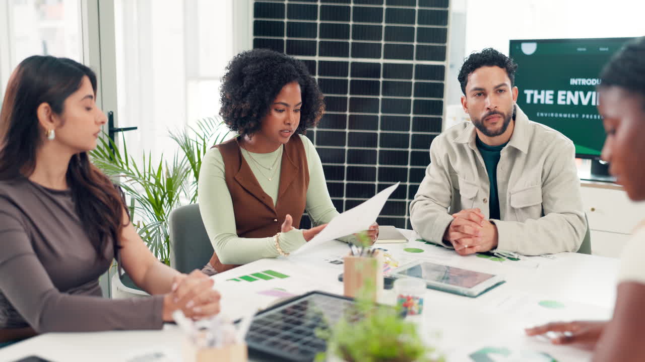 Diverse Business Team Discussing Environmental Strategy in Modern Office