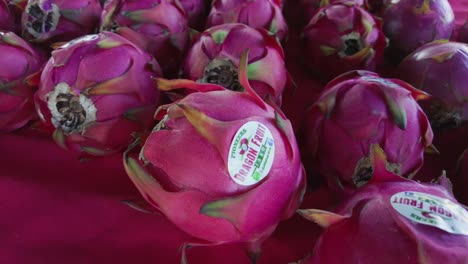 dragon fruit sitting on a table for sale