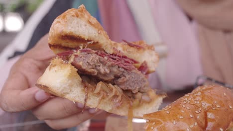 close up of a delicious hamburger being eaten