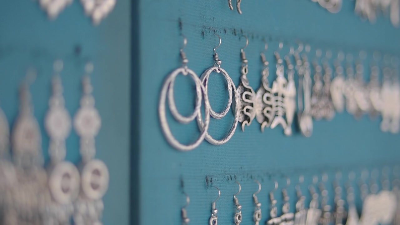 Silver Earrings Displayed on a Blue Wooden Board