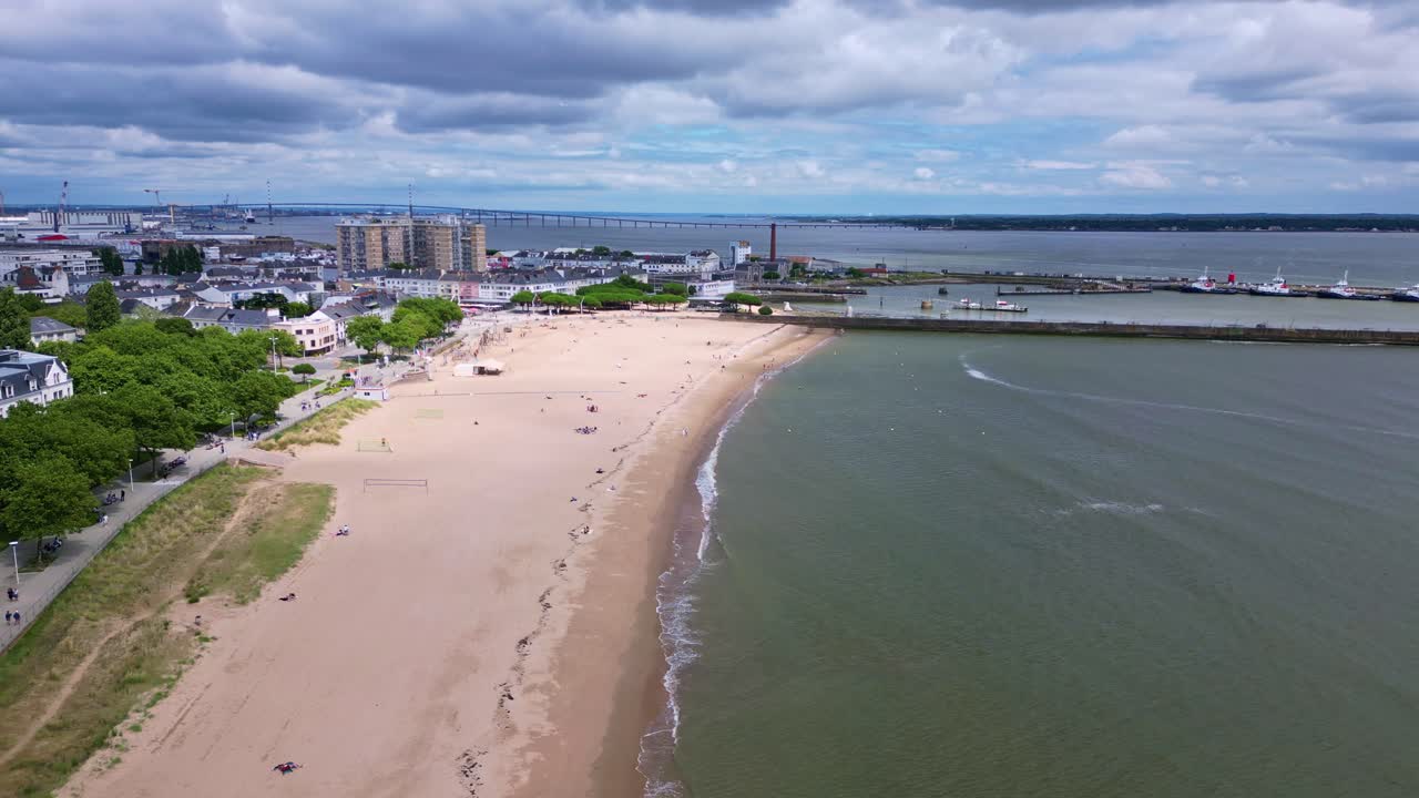 Aerial View of Urban Beach and Coastal City with Long Bridge