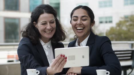 businesswomen having video chat via tablet pc