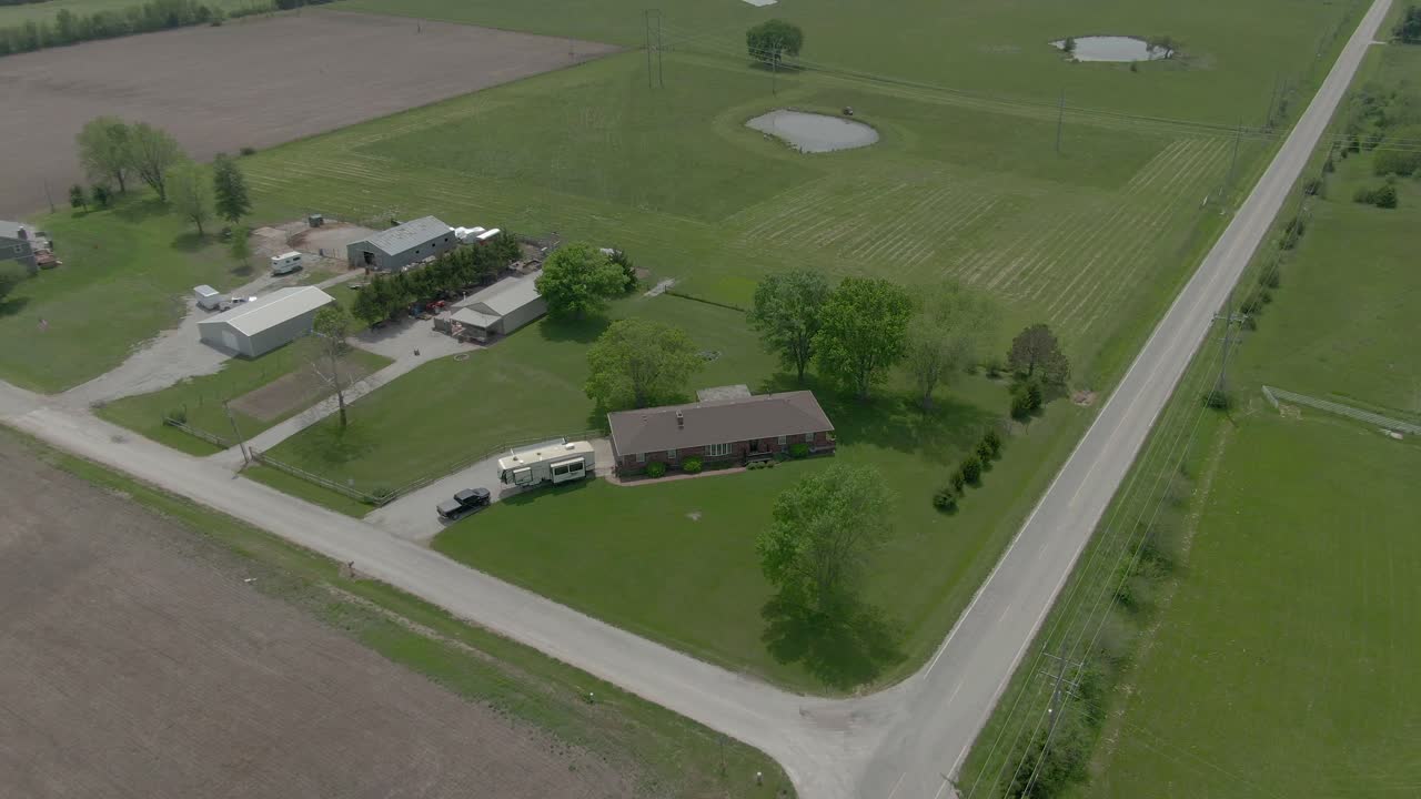 Aerial view moves down Country road in Kansas