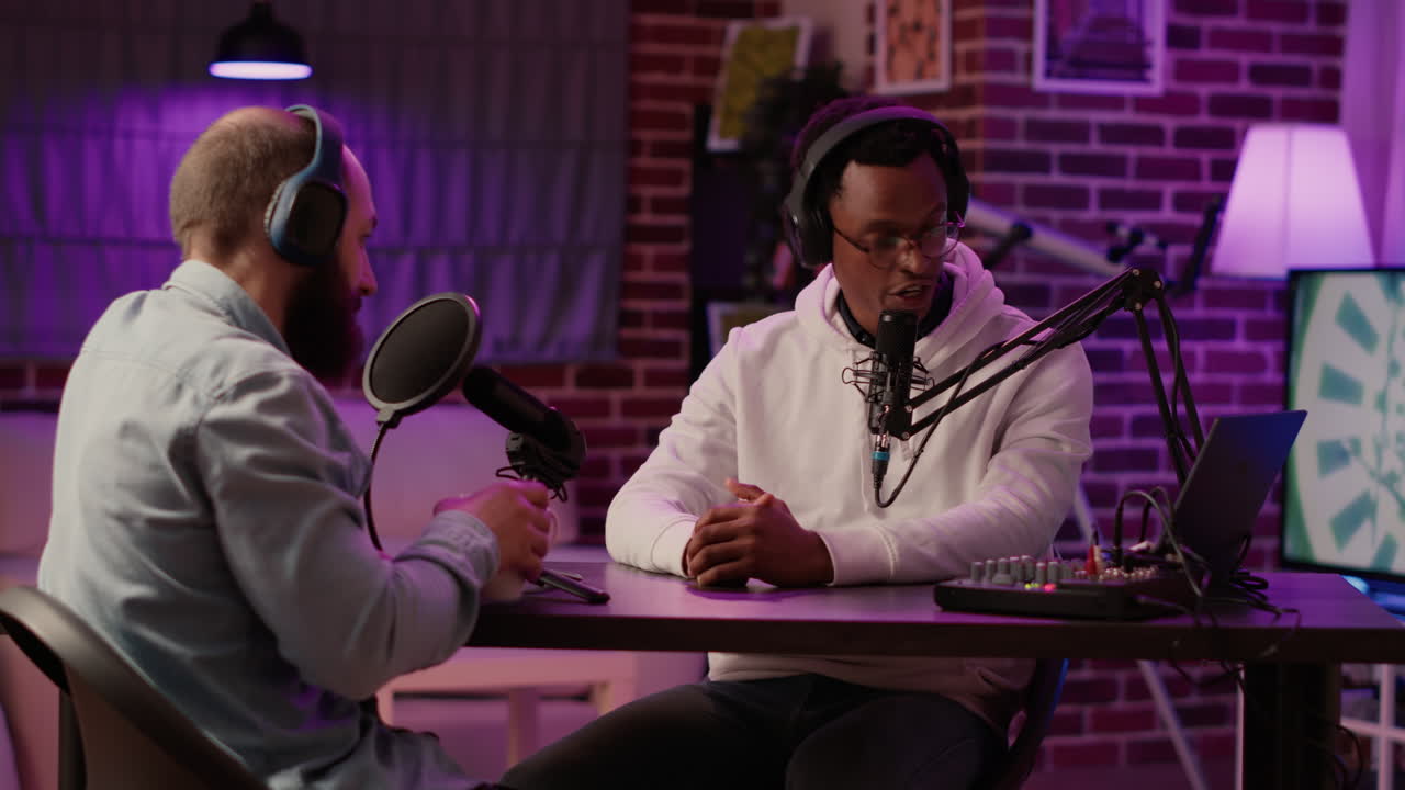 African american podcaster in interview with famous influencer greeting guest doing fist bump