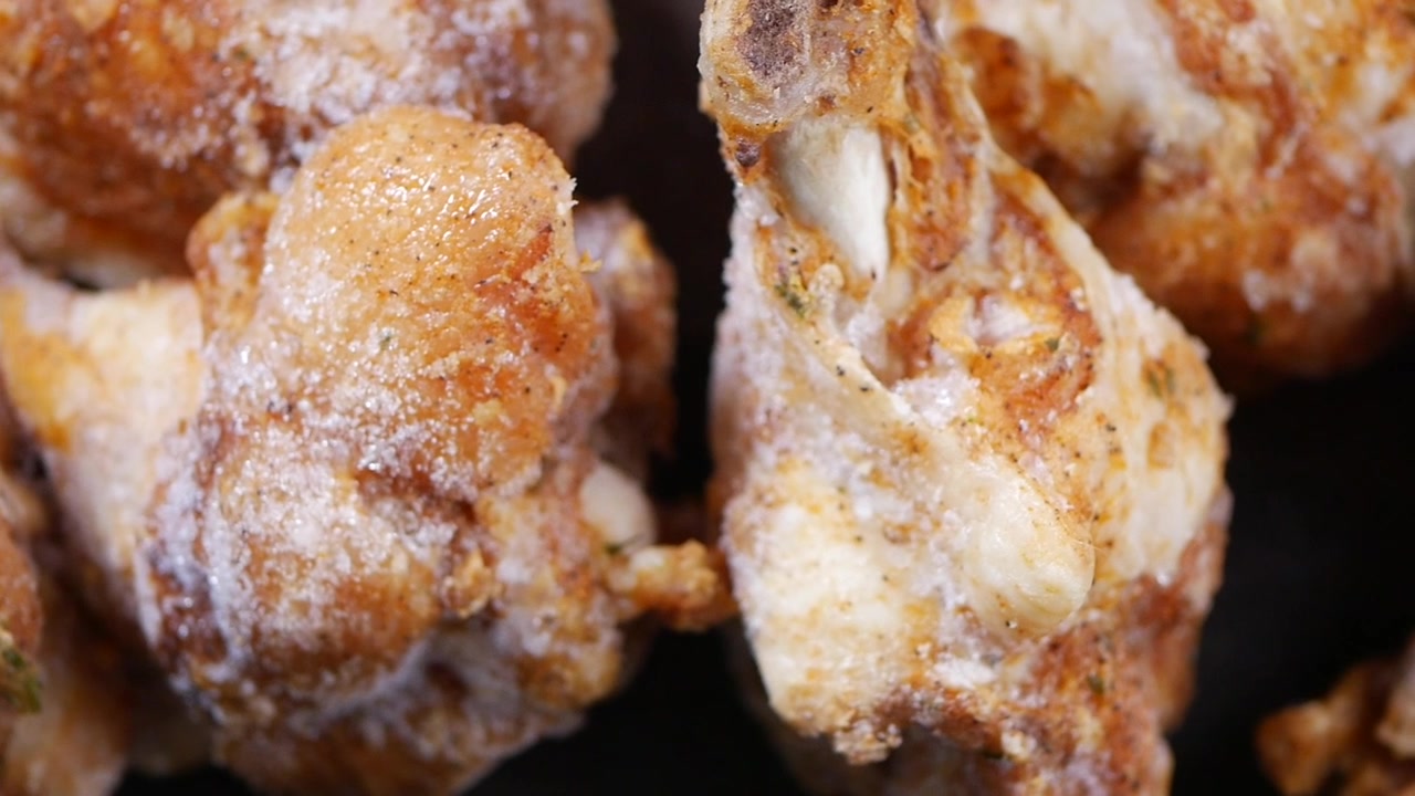 Close-up of Frozen Raw Chicken Wings and Drumettes with Seasoning