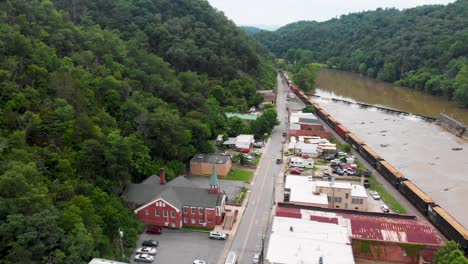 aerial view of a small town beside a river and train tracks