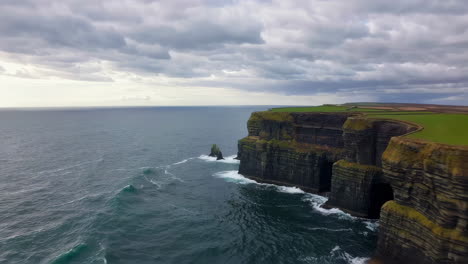dramatic cliffs of moher with crashing atlantic waves