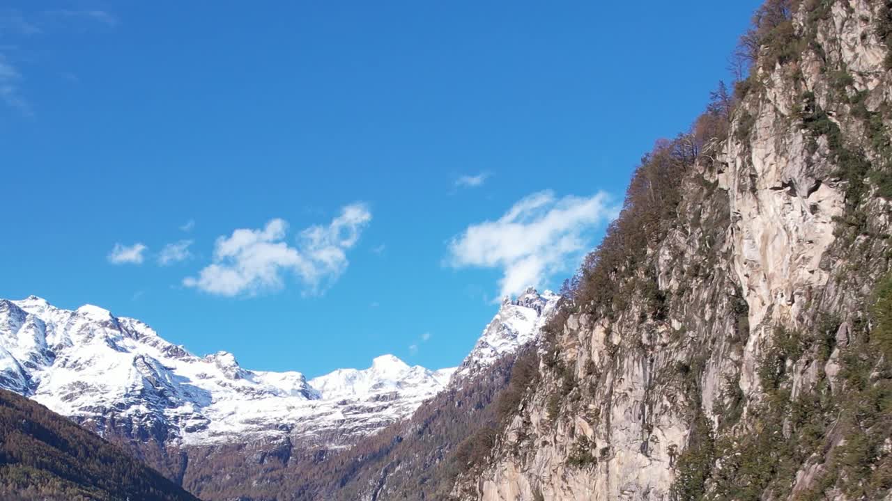 Stunning aerial view of the Alps in Italy reveals majestic cliffs and snow