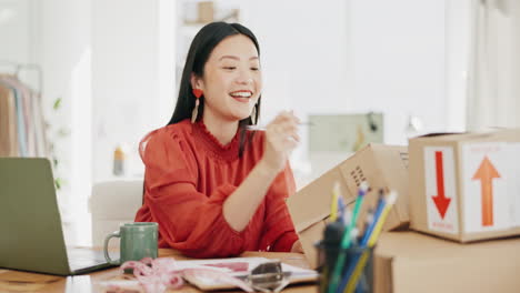 Box,-ecommerce-and-laptop-with-asian-woman-writing