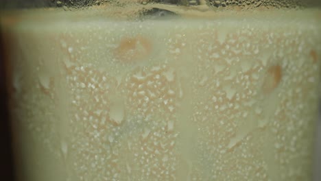 close-up of condensation on a glass containing a cold liquid