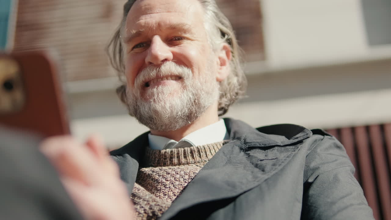 Smiling Mature Man on Video Call Outdoors