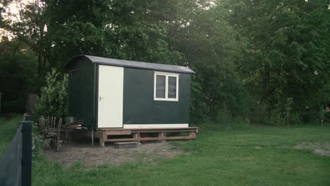 Little-house-in-a-garden-with-trees-behind