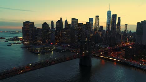 manhattan skyscrapers and brooklyn bridge illuminated at twilight