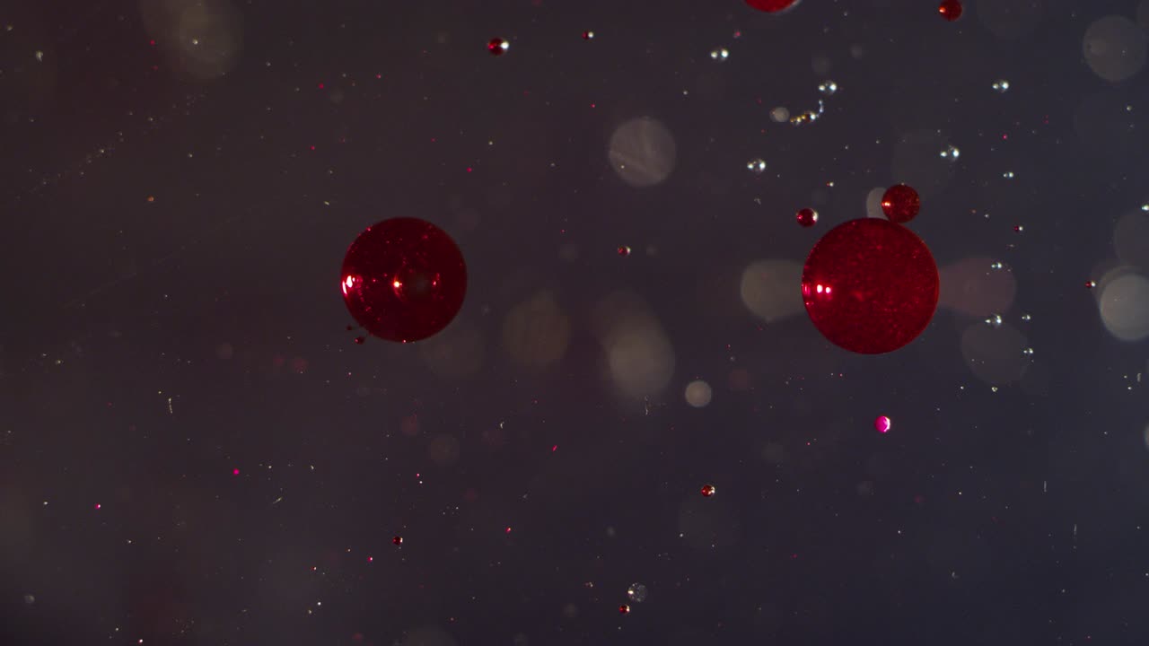 abstracto dos orbes rojas brillantes flotando en el fondo de textura líquida