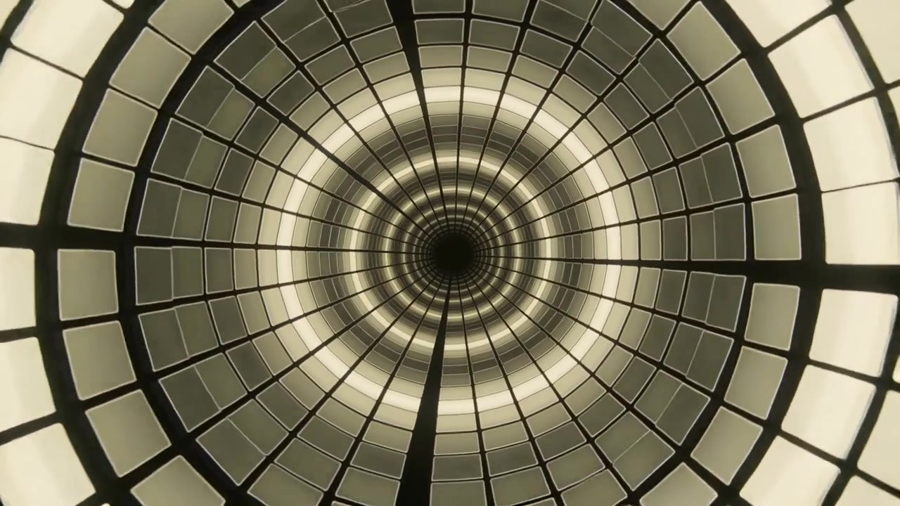 Zooming camera revealing concentric light rings with radial ribs in lobby, drawing into aperture