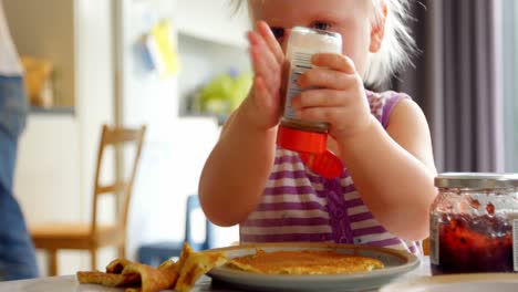 baby playing with pepper on dining table 4k