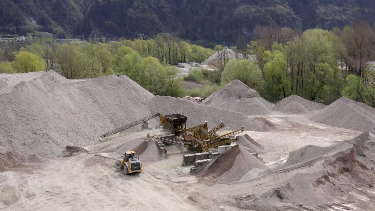 Panoramic drone movement around a cement quarry operations on a mining site.