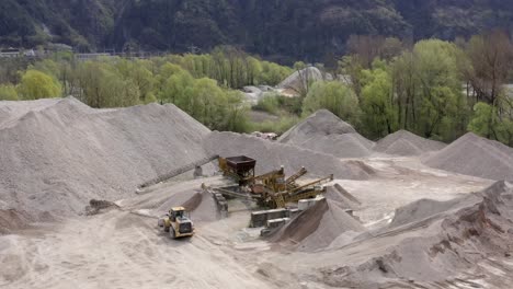 panoramic drone movement around a cement quarry operations on a mining site.