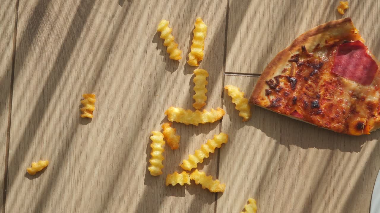 Pizza Slice and French Fries on Table