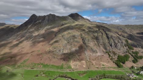 High-altitude-pan-of-Langdale-Pikes-mountain-range-with-moving-cloud-shadows