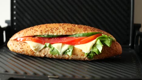 grilled cheese sandwich with tomatoes, lettuce, and cucumbers